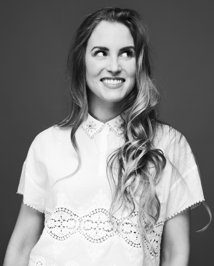 A black and white photograph of Dr Laura Joan Salm smiling while looking off camera.